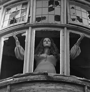 Woman posing with broken windows