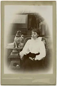 Woman with a pug dog in a garden
