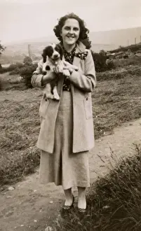 Woman and puppy on a hillside