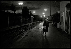Images Dated 7th November 2013: Woman on railway station platform late evening, Italy