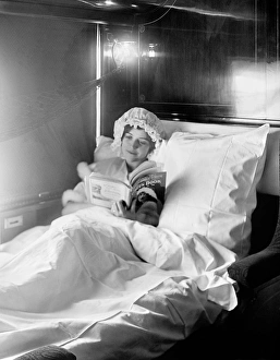 Berth Collection: Woman reading in an Electric-lighted sleeper berth