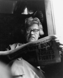 Images Dated 26th May 2017: Woman reading a newspaper on a train