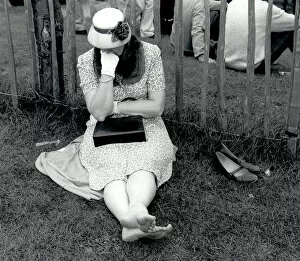 Woman resting on grass at Goodwood, West Sussex