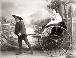 Rickshaw Collection: Woman in a rickshaw in a studio setting, Japan