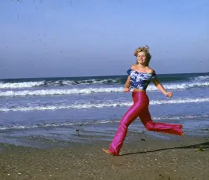 Skimpy Prints: Woman running on a beach, Cornwall