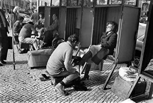 Shining Collection: Woman in shoe shine booth Lisbon