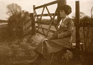 Images Dated 31st October 2018: Woman sitting on a stile by a five-bar gate