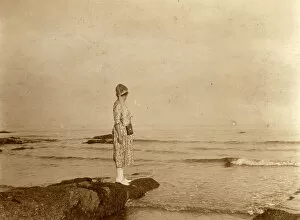 Images Dated 31st October 2018: Woman standing on a rock looking out to sea