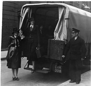 Woman stepping out of the back of a covered van Woman stepping out of the back of a covered van
