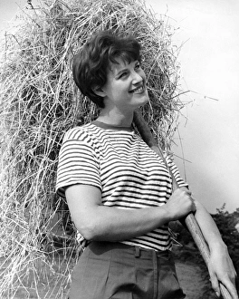 Images Dated 22nd November 2016: Woman with straw at harvest time