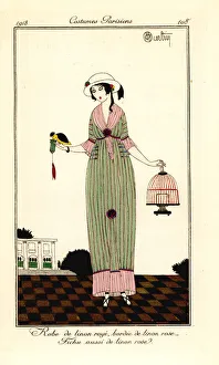 Images Dated 18th April 2019: Woman in striped linen dress holding a bird and cage, 1913