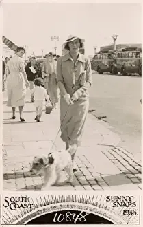 Walkies Prints: Woman with terrier on a lead at the seaside