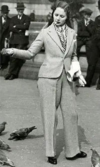 Trouser Prints: Woman in trouser suit feeding pigeons, Trafalgar Square