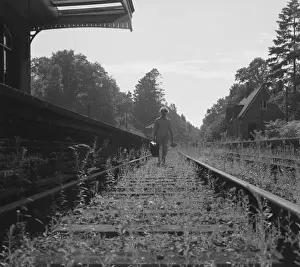 Weeds Prints: Woman walking along a disused railway track