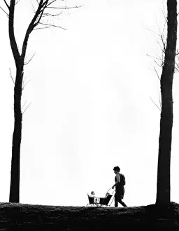 Autumnal Prints: Woman wheeling two babies in a pram