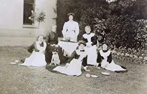 Pinafore Prints: Six women with a dog in a garden