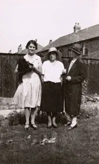 Tortoises Prints: Three women with a dog and tortoises in a garden