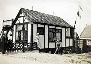 Beret Collection: Two women in fashionable holiday outfits pose for their photograph outside their chalet