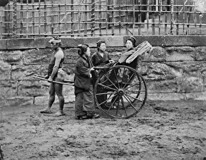 Women beside a jinrikisha (Japanese rickshaw), Japan