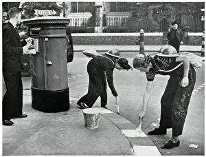 Precaution Prints: Women painting kerbside for blackouts, September 1939