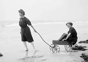 Two women in period bathing costumes on the beach in America