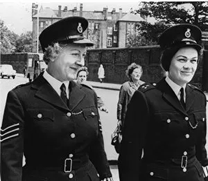 Sleeve Gallery: Two women police officers walking along London street