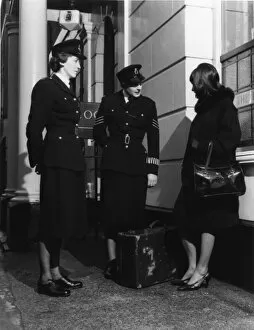 Peaked Collection: Two women police officers and woman with suitcase