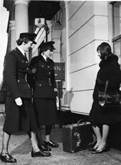 Two women police officers and woman with suitcase
