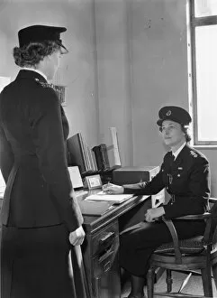 Policewoman Gallery: Two women police officers at work in a station, London