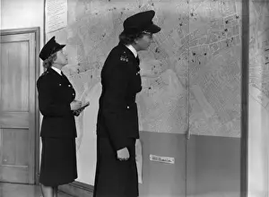 Two women police officers working in a station, London