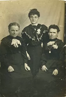 Three women, probably from the same family, all in black, possibly in mourning