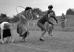 Women running a race with hoops