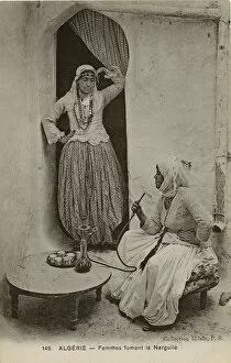 Images Dated 7th December 2015: Two women smoke from a hookah pipe, Algeria
