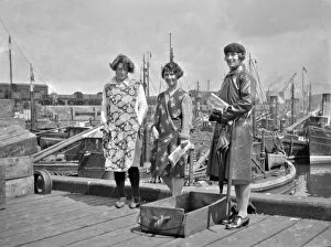 Aprons Gallery: Three women standing by a harbour