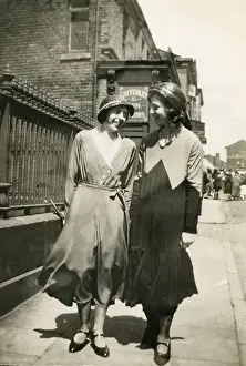 Laughing Prints: Two women walking together along a street