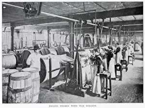 Women working in a large factory making wax candles with a foreman standing watching them