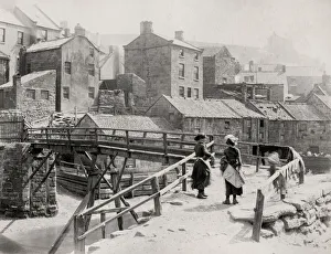 Cityscape Prints: Wooden bridge over a stream at Staithes, Yorkshire