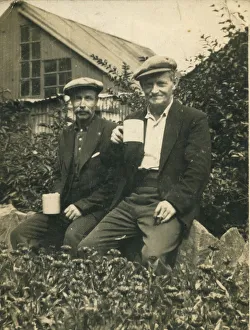 Two working class men enjoying a break from work with a cup of tea. Date: 1920s Two working class men enjoying a break from work with a cup of tea. Date: 1920s
