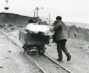 Quarrying Prints: Workman pushing slate quarry tram, North Wales