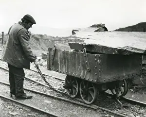 Quarrying Prints: Workman with slate quarry tram, North Wales