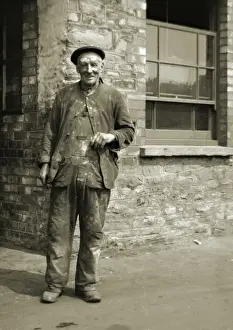 Forehead Prints: Workman standing outside a building