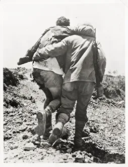 World War II US soldier helped towards the rear World War II US soldier helped towards the rear