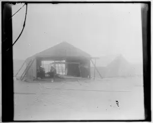Wright brothers rebuilding their glider in a wooden shed ere