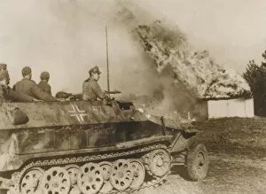 WW2 - German tank driving through a burning Russian village