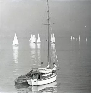 Coasts Collection: Yacht at rest with National 12 dinghies in twilight