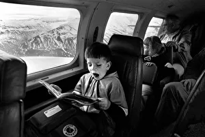 Yawning boy reads comic during an internal flight in Iceland Yawning boy reads comic during an internal flight in Iceland