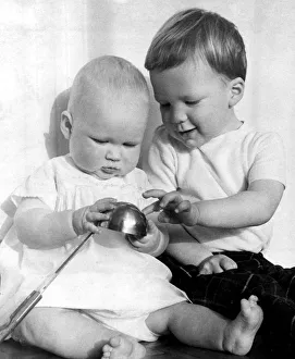 Images Dated 30th October 2019: Three year-old old boy explaining a reflection to his baby s