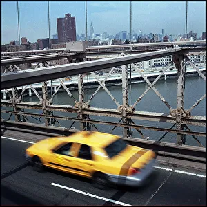 Yellow cab taxi on Brooklyn Bridge, New York, USA