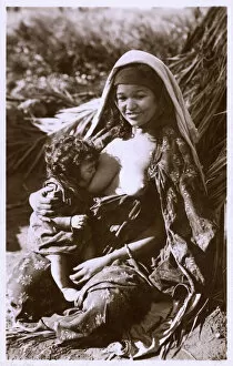 Infant Collection: Young Algerian Mother breastfeeding her infant