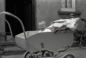 A young baby in a fine perambulator